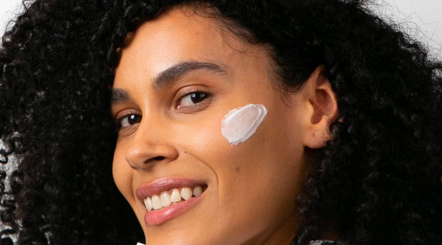 Woman with afro with the Grahams Natural eczema cream on their face